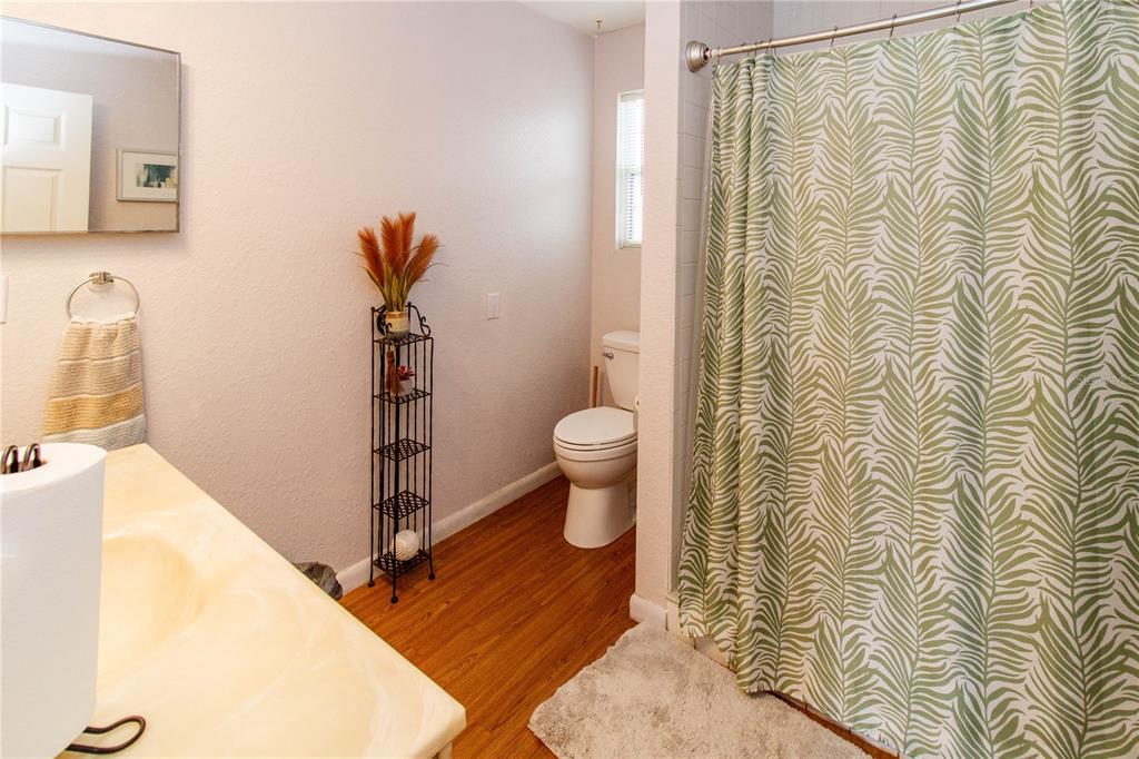 525 4th Avenue Southwest Largo, FL 33770 - Photo 15 of 27 a bathroom with a shower and a toilet
