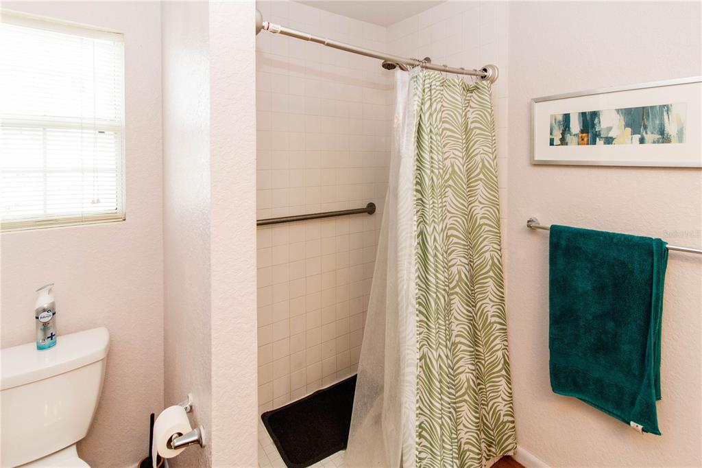 525 4th Avenue Southwest Largo, FL 33770 - Photo 16 of 27 a bathroom with a shower curtain a sink and a toilet