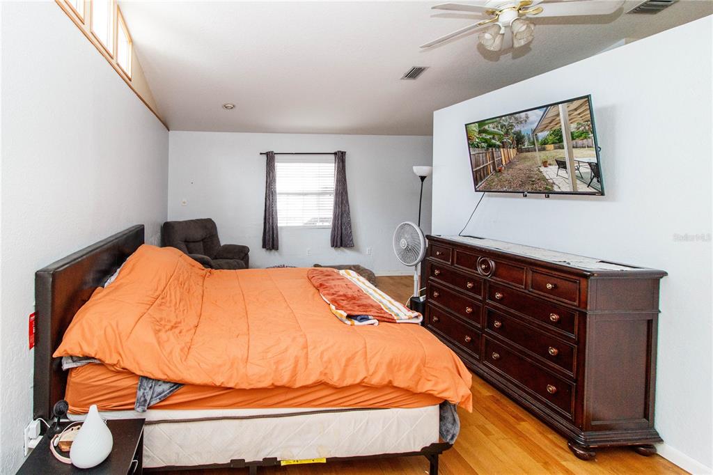 525 4th Avenue Southwest Largo, FL 33770 - Photo 21 of 27 a bedroom with a bed and lamp with window