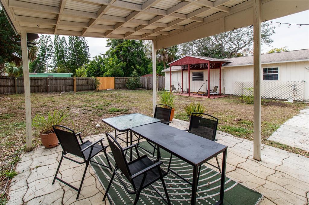 525 4th Avenue Southwest Largo, FL 33770 - Photo 27 of 27 a view of a patio with a table chairs and a backyard
