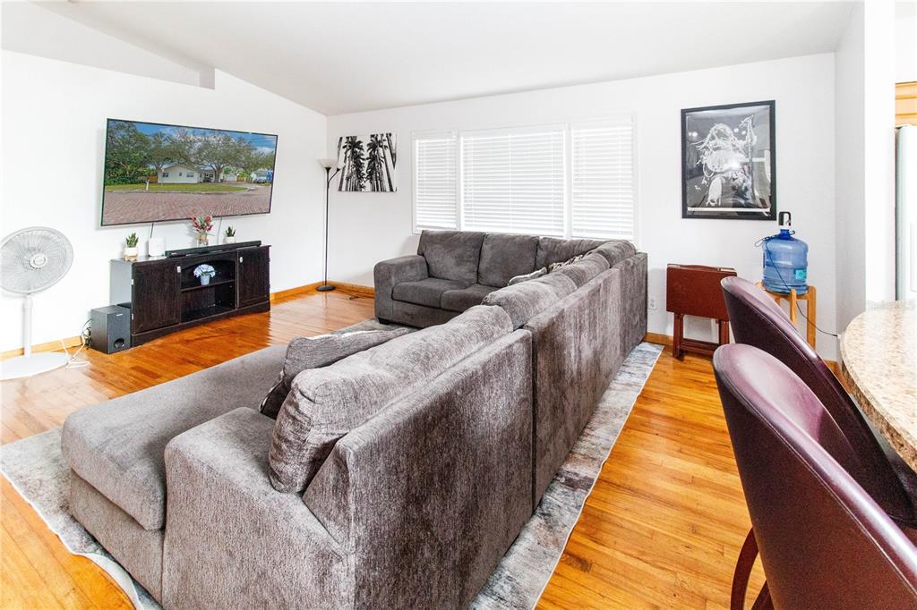 525 4th Avenue Southwest Largo, FL 33770 - Photo 4 of 27 a living room with furniture and a flat screen tv