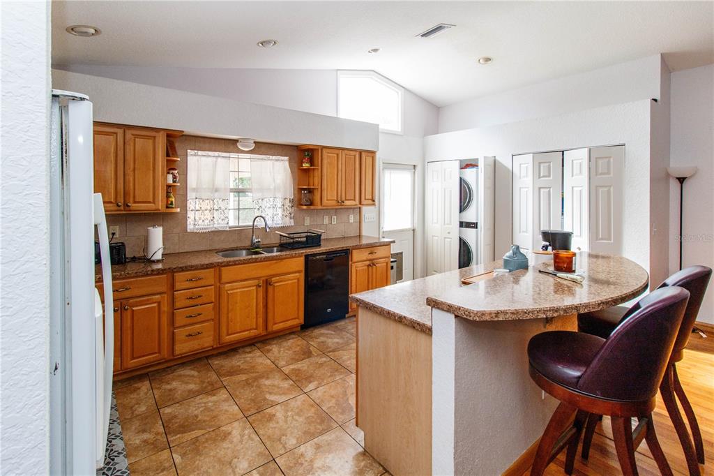 525 4th Avenue Southwest Largo, FL 33770 - Photo 5 of 27 a kitchen with a sink stove and chairs