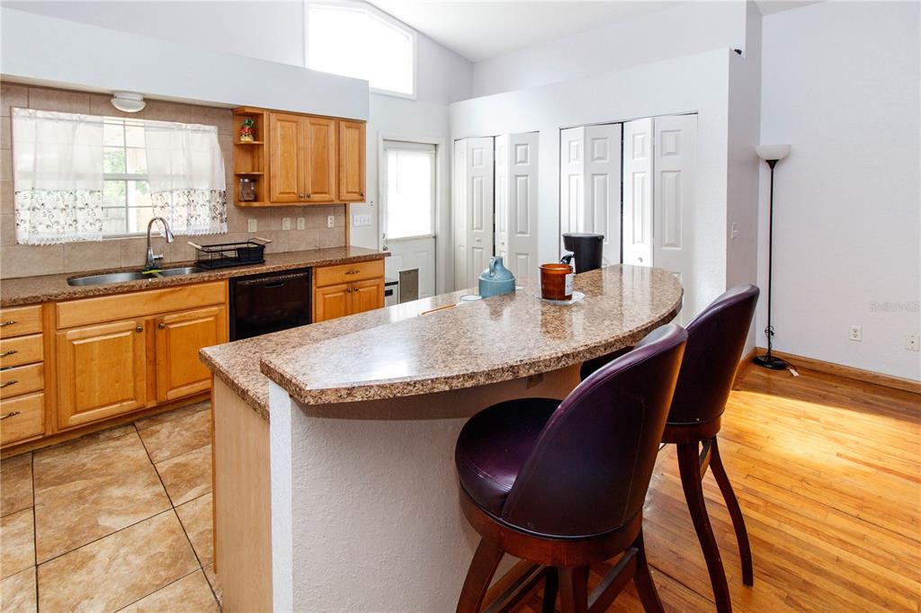 525 4th Avenue Southwest Largo, FL 33770 - Photo 10 of 27 a kitchen with granite countertop sink stove and dining table