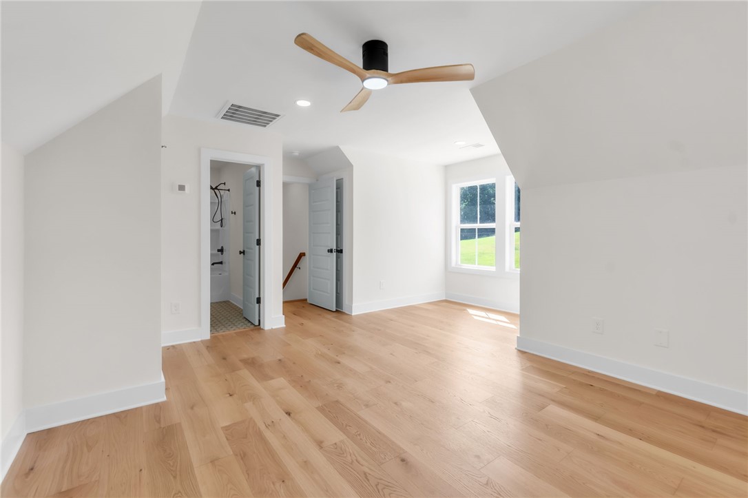 574 Paramount Drive Seneca, SC 29678 - Photo 26 of 45 An airy loft space presents rich wood flooring and a modern ceiling fan.