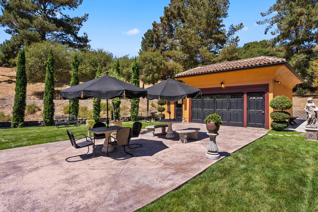 2970 Freedom Boulevard Watsonville, CA 95076 - Photo 37 of 58 a view of a patio with chairs and table under an umbrella with a barbeque grill and plants