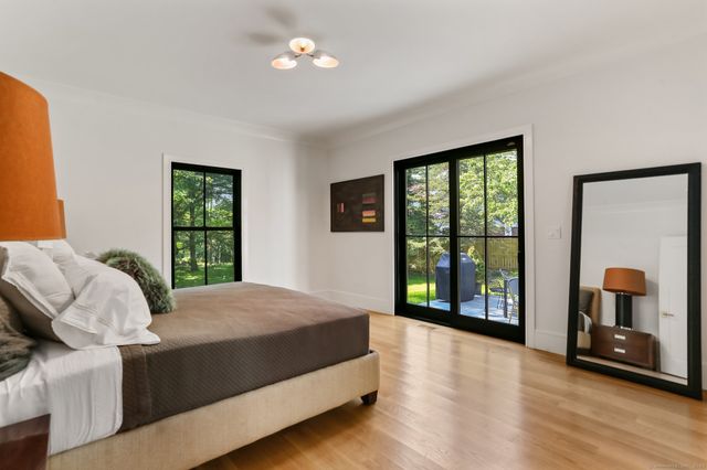 a bedroom with a large bed and a large window