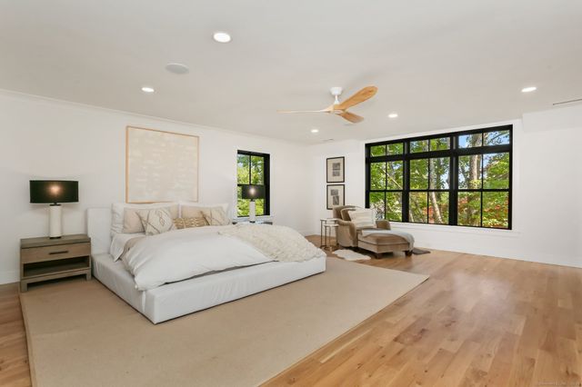 a spacious bedroom with a large bed and a large window
