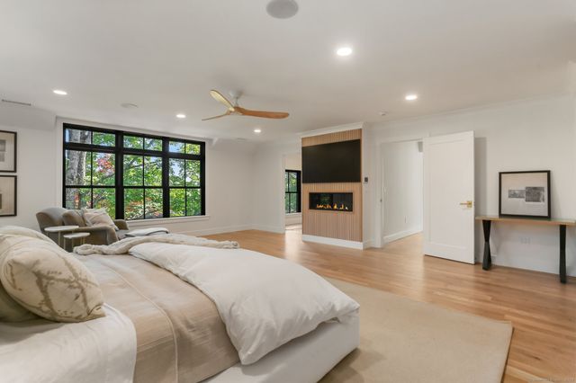 a spacious bedroom with a large bed and a large window