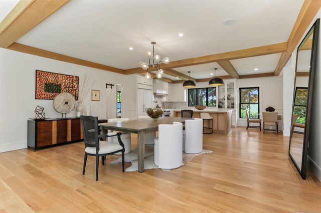 a living room with lots of furniture and kitchen view