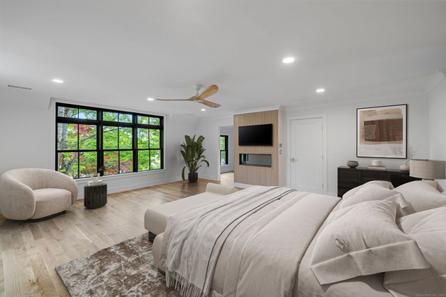 a spacious bedroom with a large bed and a large window