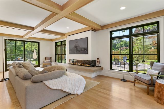a living room with furniture and large windows