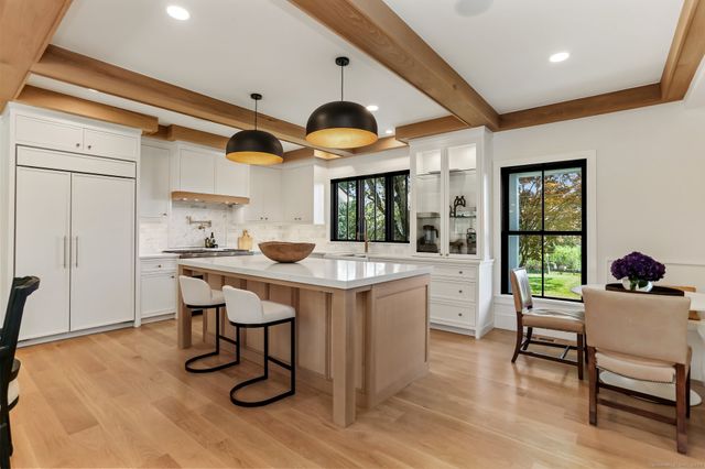 a kitchen with a sink cabinets and wooden floor