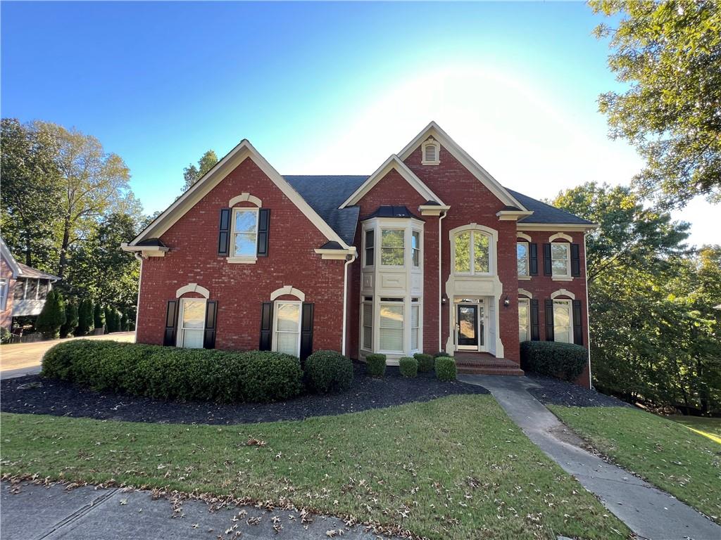 Undisclosed Address Kennesaw, GA 30144 - Photo 1 of 51 a front view of a house with garden
