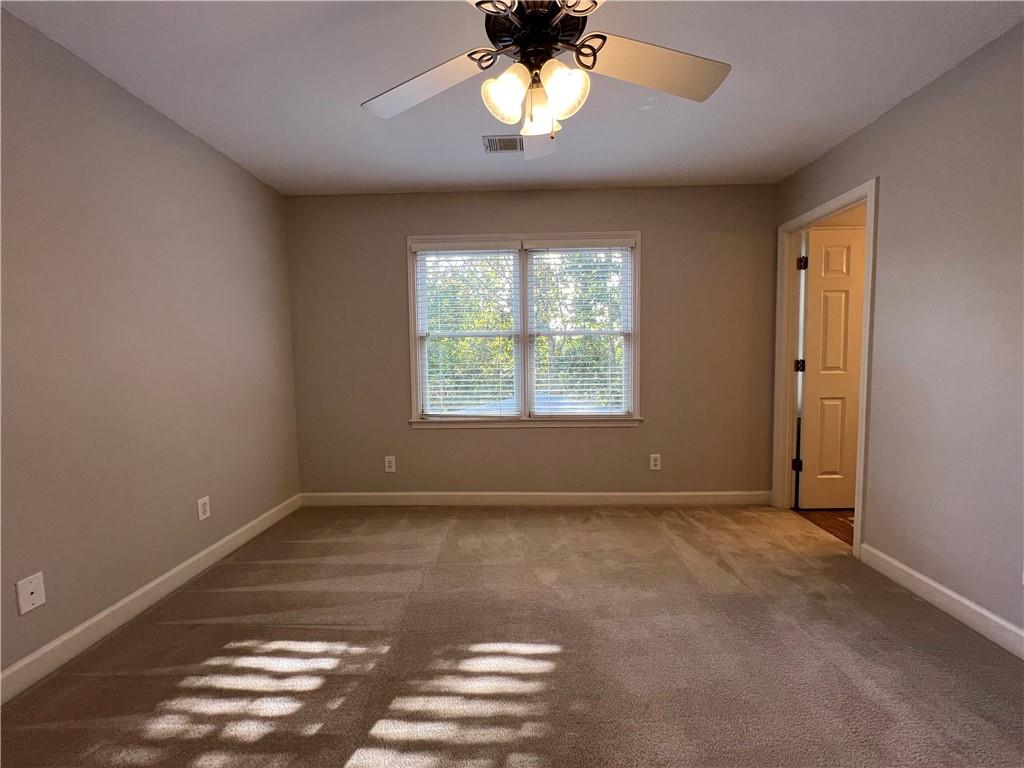 Undisclosed Address Kennesaw, GA 30144 - Photo 31 of 51 an empty room with windows and ceiling fan