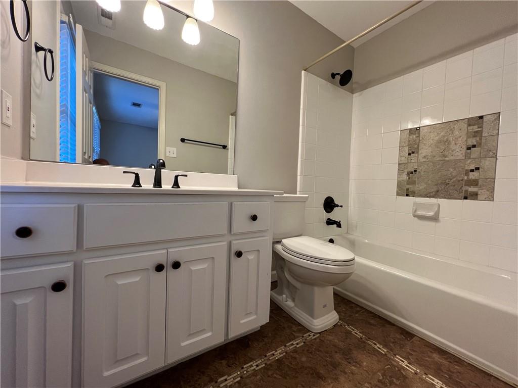Undisclosed Address Kennesaw, GA 30144 - Photo 32 of 51 a bathroom with a toilet a sink a mirror and a bathtub