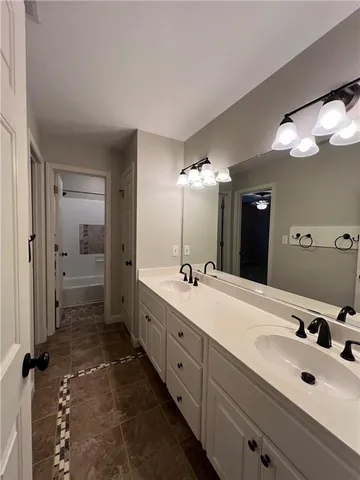 a view of an empty room with a ceiling fan