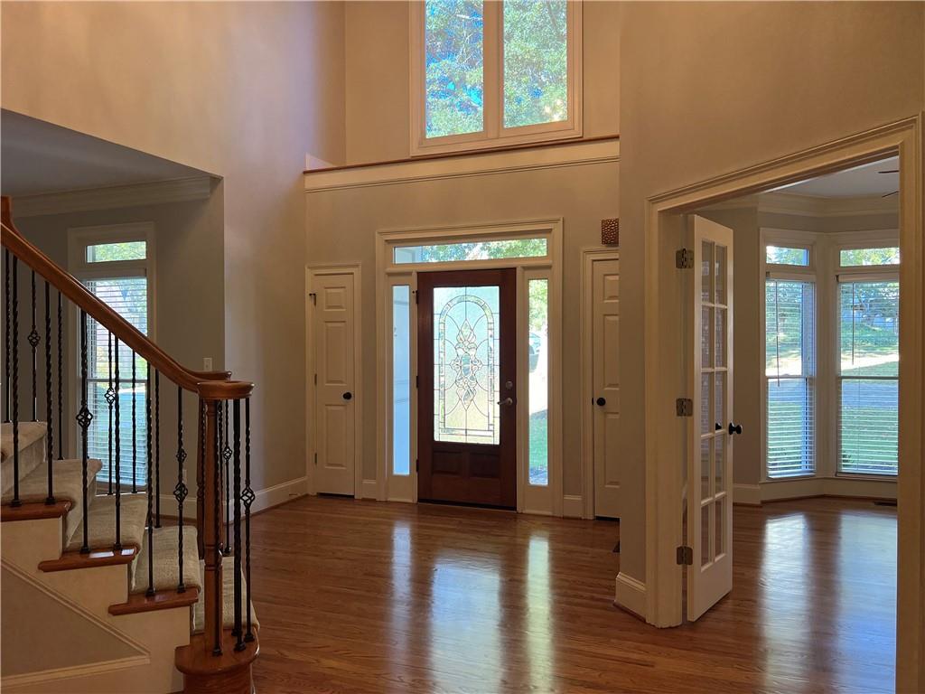 Undisclosed Address Kennesaw, GA 30144 - Photo 4 of 51 a view of a hallway with wooden floor and windows