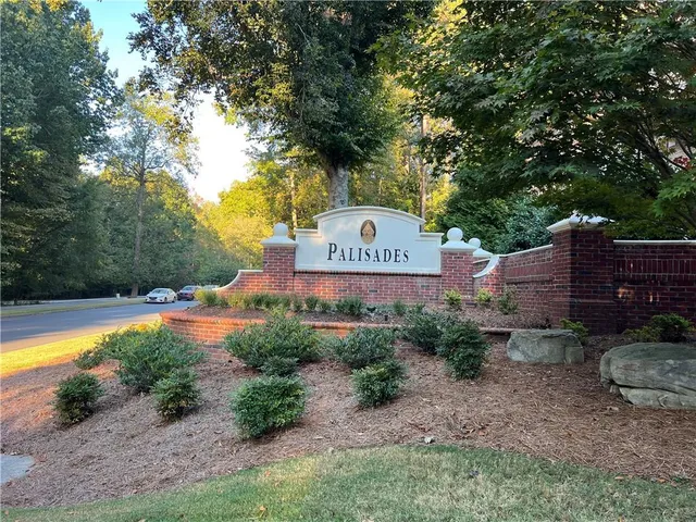 a view of yard with tree in front of it