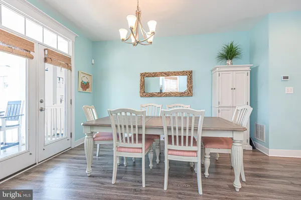 a view of a hallway with wooden floor and entryway