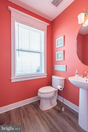 a view of a bedroom with a bed and a window