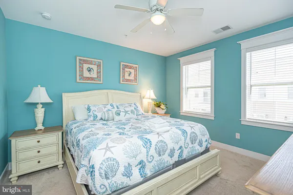 a bedroom with a large bed and a large window