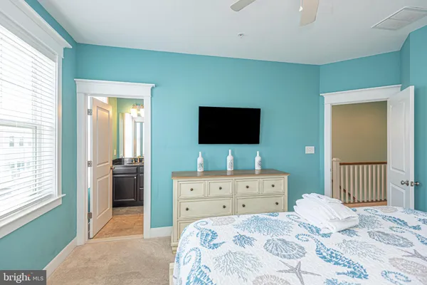 a en suite bathroom with a granite countertop sink and a mirror