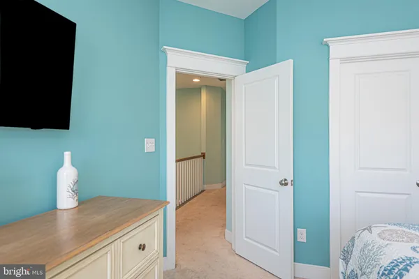 a view of a hallway with wooden floor and entryway