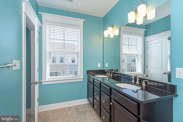 a view of a white building among the street with palm trees