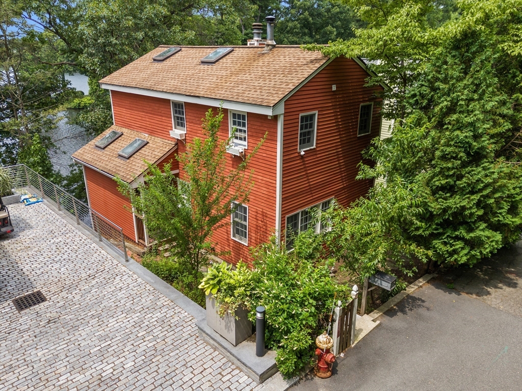 75 Russell Road Wellesley, MA 02482 - Photo 1 of 30 an aerial view of a house with a yard and potted plants