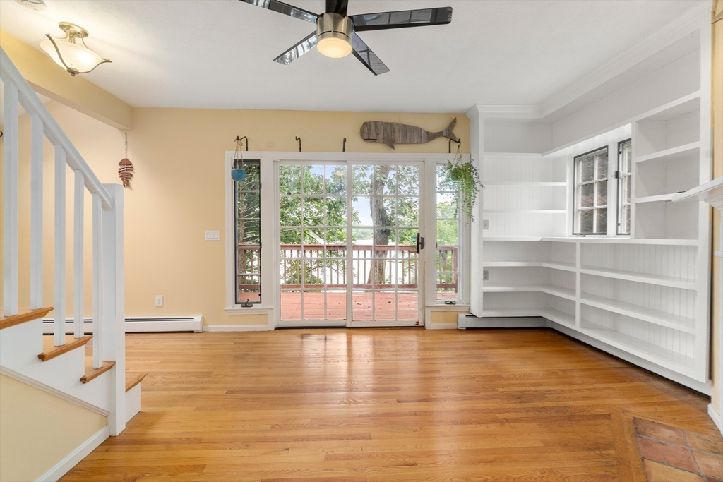 75 Russell Road Wellesley, MA 02482 - Photo 11 of 30 a view of an empty room with a window and wooden floor
