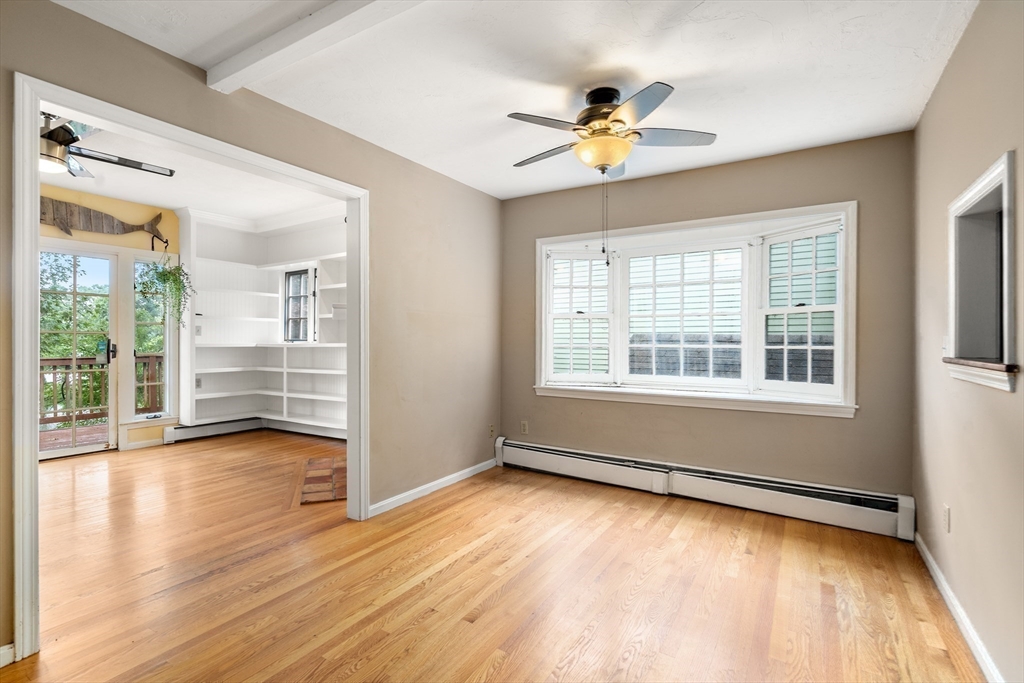 75 Russell Road Wellesley, MA 02482 - Photo 12 of 30 a view of an empty room with wooden floor and a window