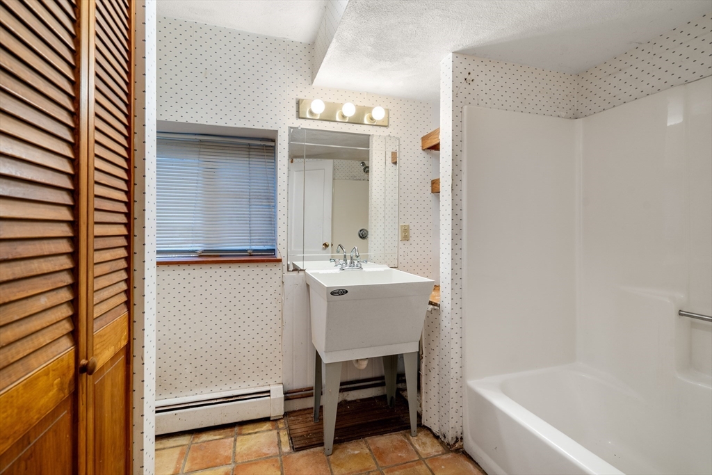 75 Russell Road Wellesley, MA 02482 - Photo 19 of 30 a bathroom with a sink tub and a mirror