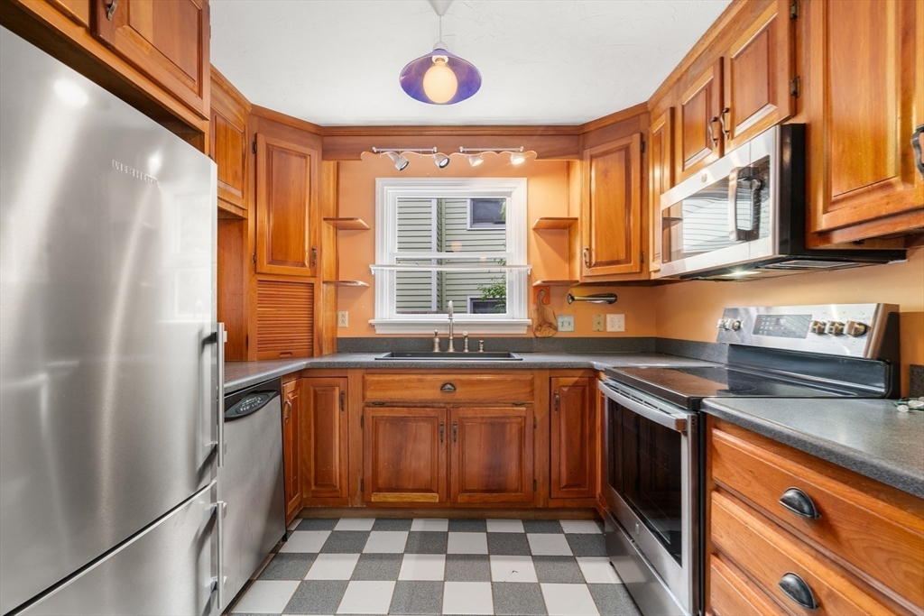 75 Russell Road Wellesley, MA 02482 - Photo 8 of 30 a kitchen with a sink stove and cabinets
