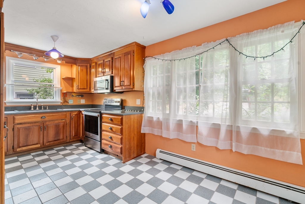 75 Russell Road Wellesley, MA 02482 - Photo 9 of 30 a kitchen with stainless steel appliances granite countertop a sink and cabinets