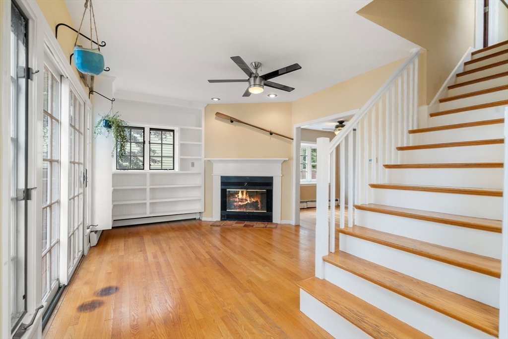 75 Russell Road Wellesley, MA 02482 - Photo 10 of 30 a view of an empty room with wooden floor fireplace and a window