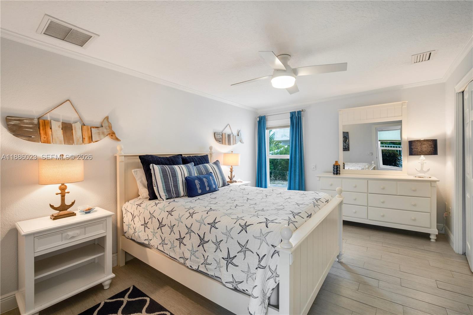 511 4th Street Key Colony Beach, FL 33051 - Photo 11 of 41 a room with a bed and a dresser