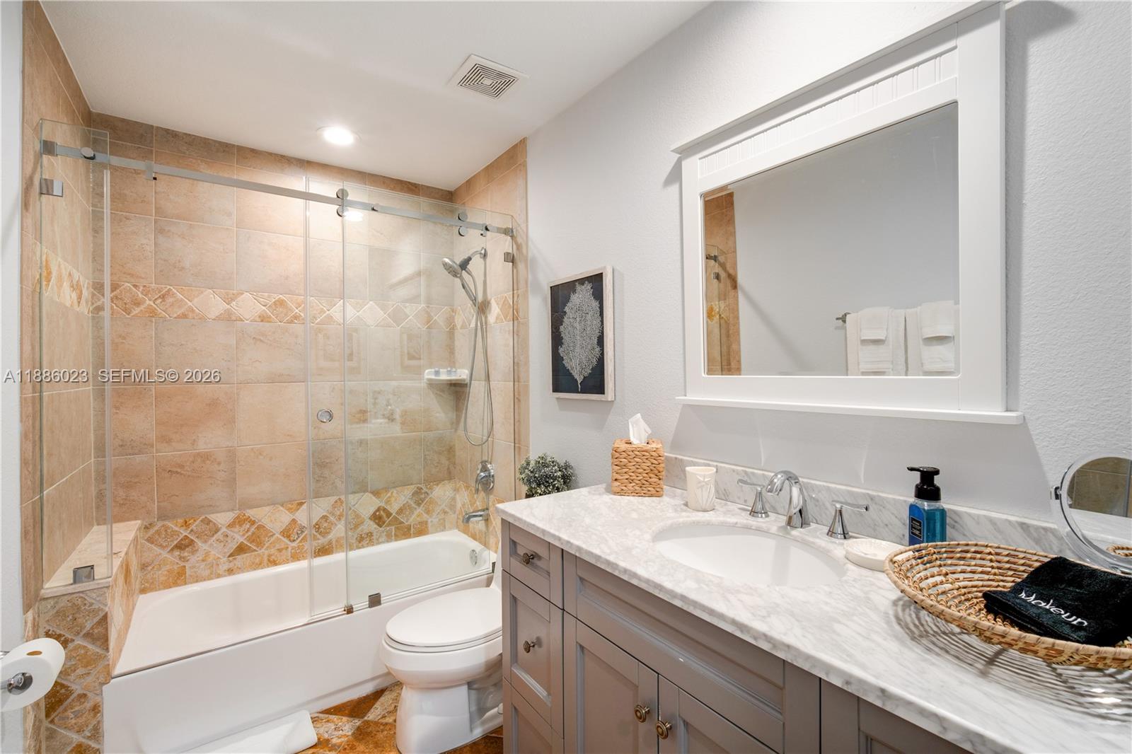 511 4th Street Key Colony Beach, FL 33051 - Photo 12 of 41 a bathroom with a granite countertop sink toilet and shower