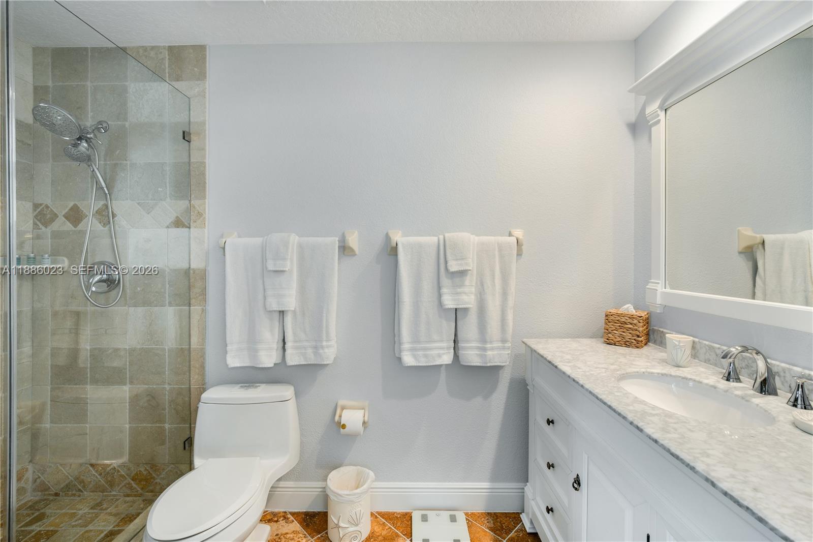 511 4th Street Key Colony Beach, FL 33051 - Photo 15 of 41 a bathroom with a granite countertop toilet sink and shower