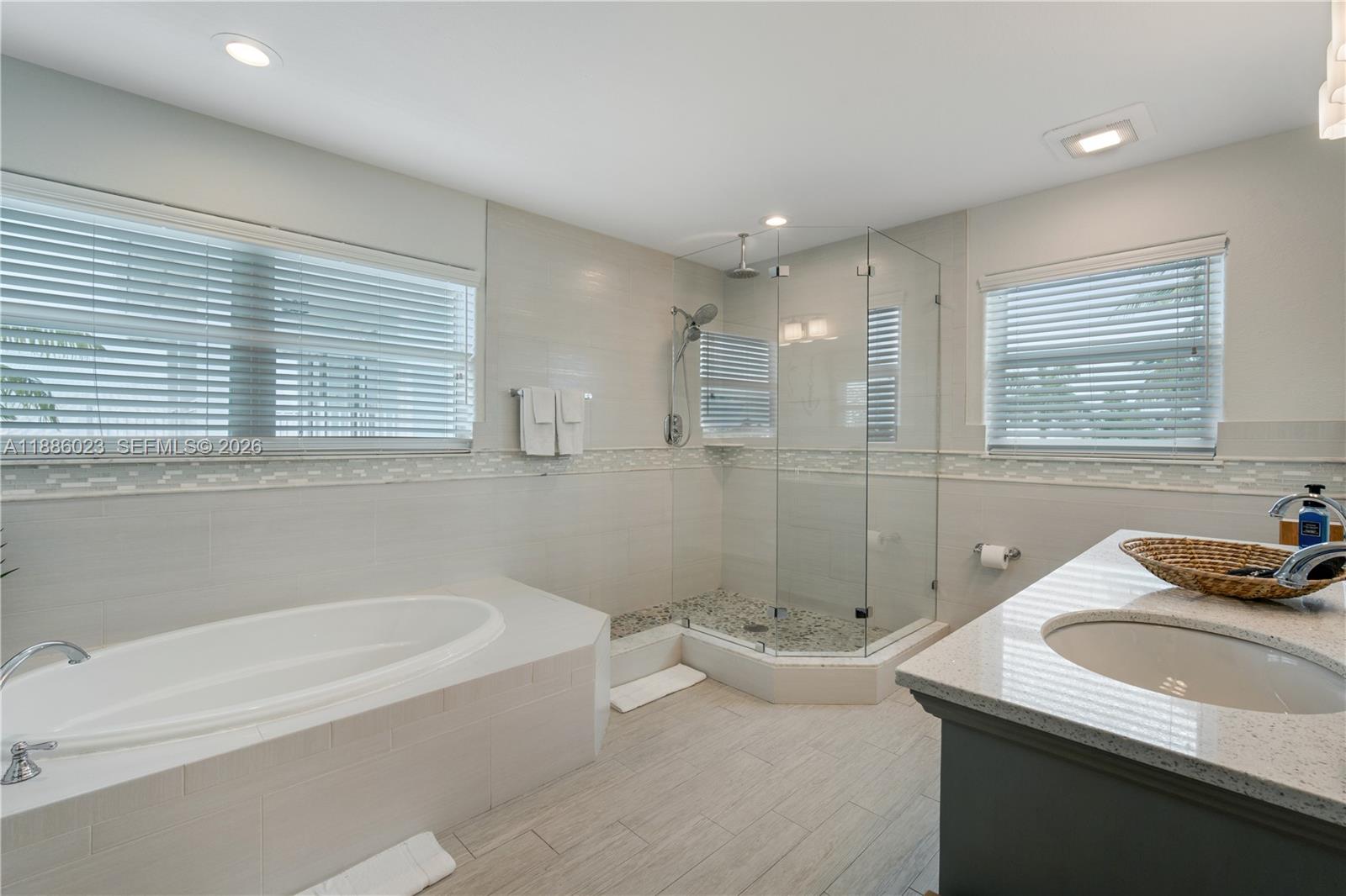 511 4th Street Key Colony Beach, FL 33051 - Photo 25 of 41 a bathroom with a tub sink and mirror