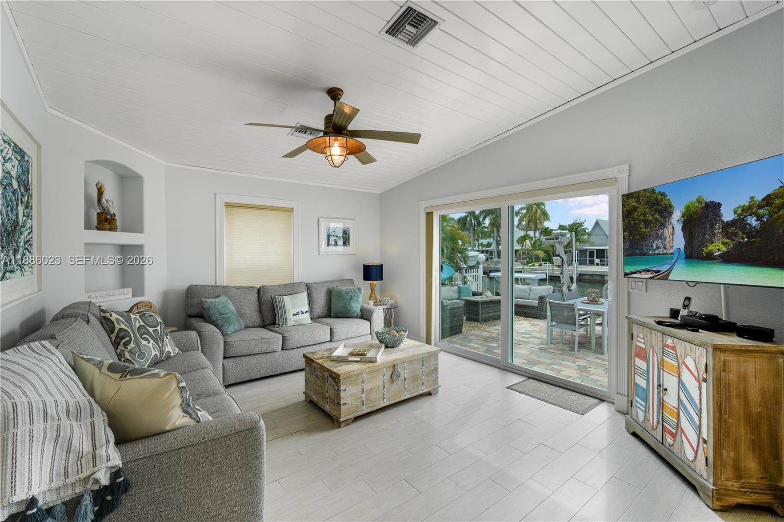511 4th Street Key Colony Beach, FL 33051 - Photo 4 of 41 a living room with furniture and a flat screen tv