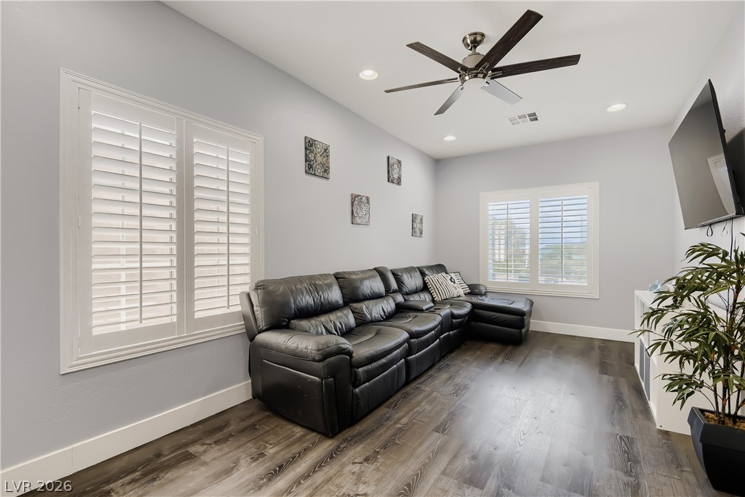 251 Integrity Ridge Drive Henderson, NV 89052 - Photo 23 of 28 A well-appointed living room offers rich flooring and ample natural light through elegant plantation shutters.