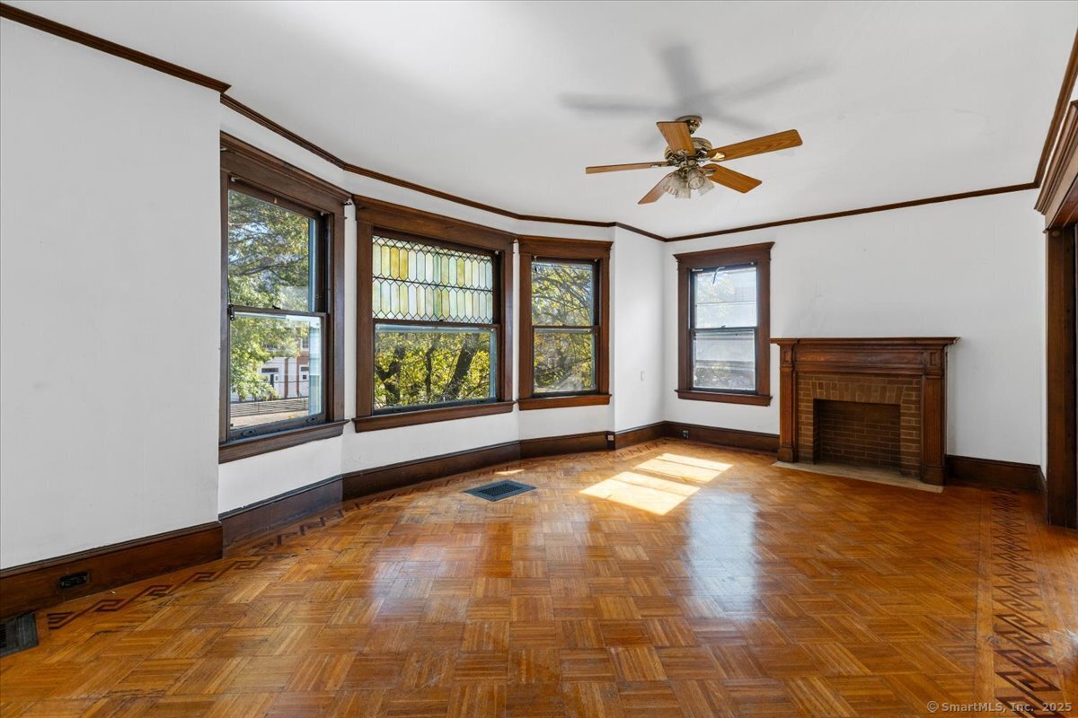 590 Whitney Avenue, Unit 2 New Haven, CT 06511 - Photo 6 of 18 a view of an empty room with a fireplace and a window