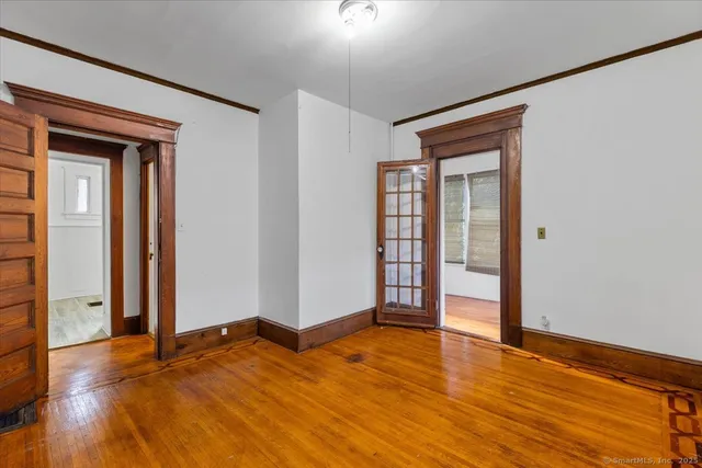 a view of empty room with wooden floor