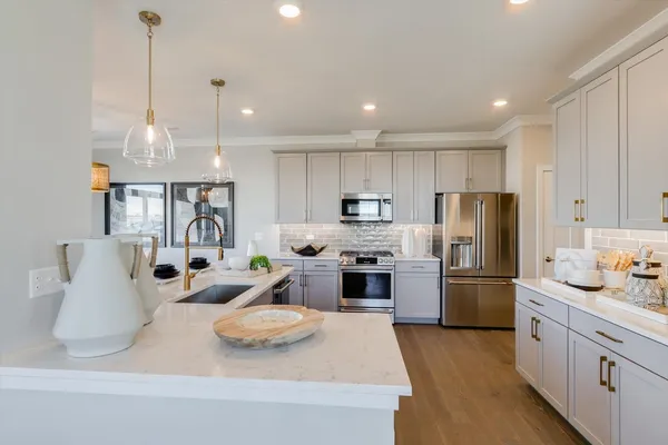 a kitchen with refrigerator a stove a sink and a cabinets