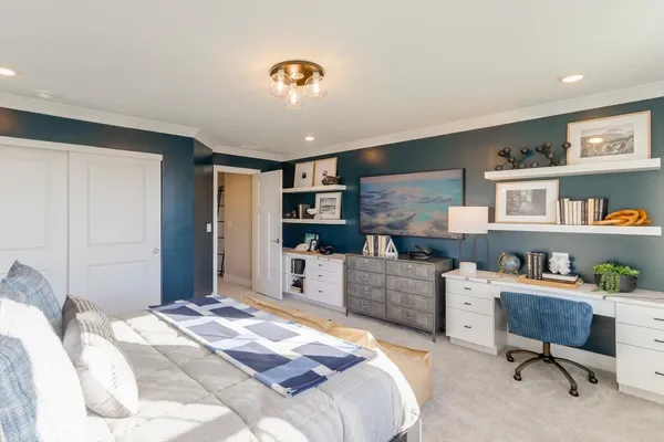 a bedroom with a workspace