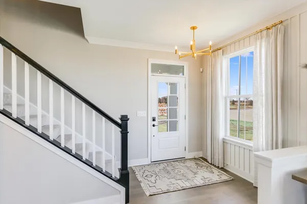 a view of an entryway with wooden floor and stairs