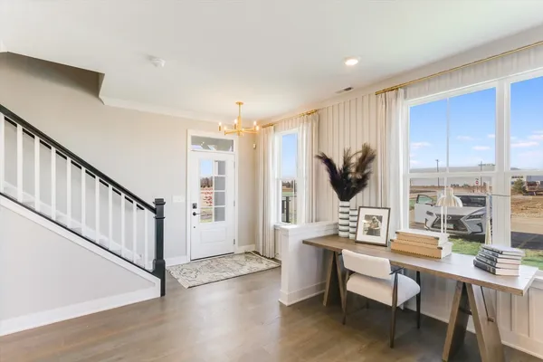 a living room with furniture window and wooden floor