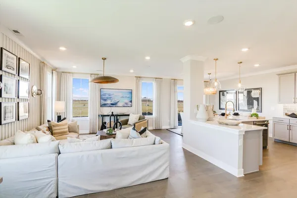 a large white kitchen with a large window and stainless steel appliances