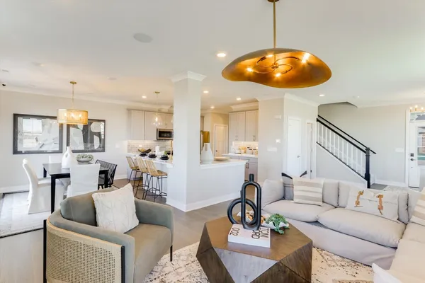 a living room with furniture and kitchen view