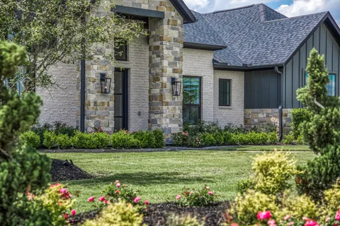 a front view of a house with garden